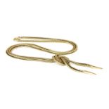 A gold fox tail knot necklace