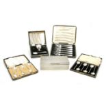 Two cased sets of six silver coffee spoons,