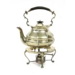 A silver kettle on stand,