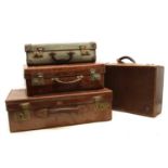 A selection of vintage leather and fabric suitcases