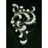 A Victorian diamond set scroll brooch,