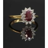 An 18ct gold ruby and diamond oval cluster ring,