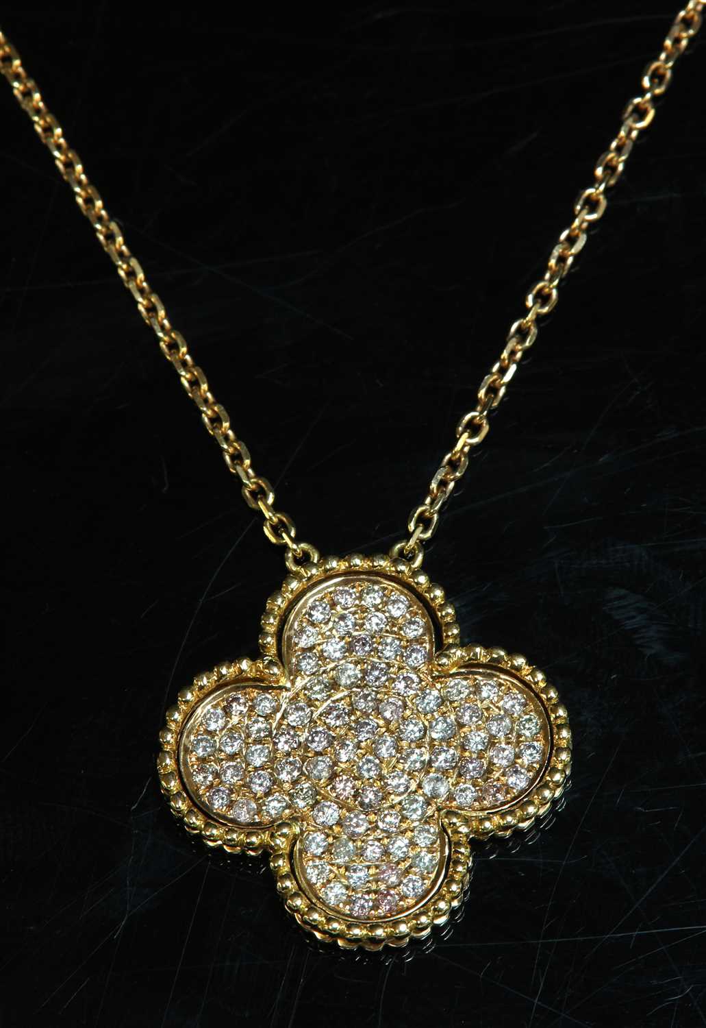 A rose gold diamond set quatrefoil pendant,