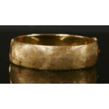 A Continental gold hinged bangle, c.1960,