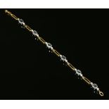 An 18ct yellow and white gold aquamarine and diamond bracelet,
