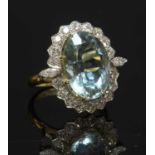 An aquamarine and diamond oval cluster ring,