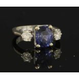 An 18ct white gold three stone sapphire and diamond ring,