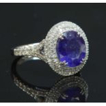 A platinum sapphire and diamond oval cluster ring,