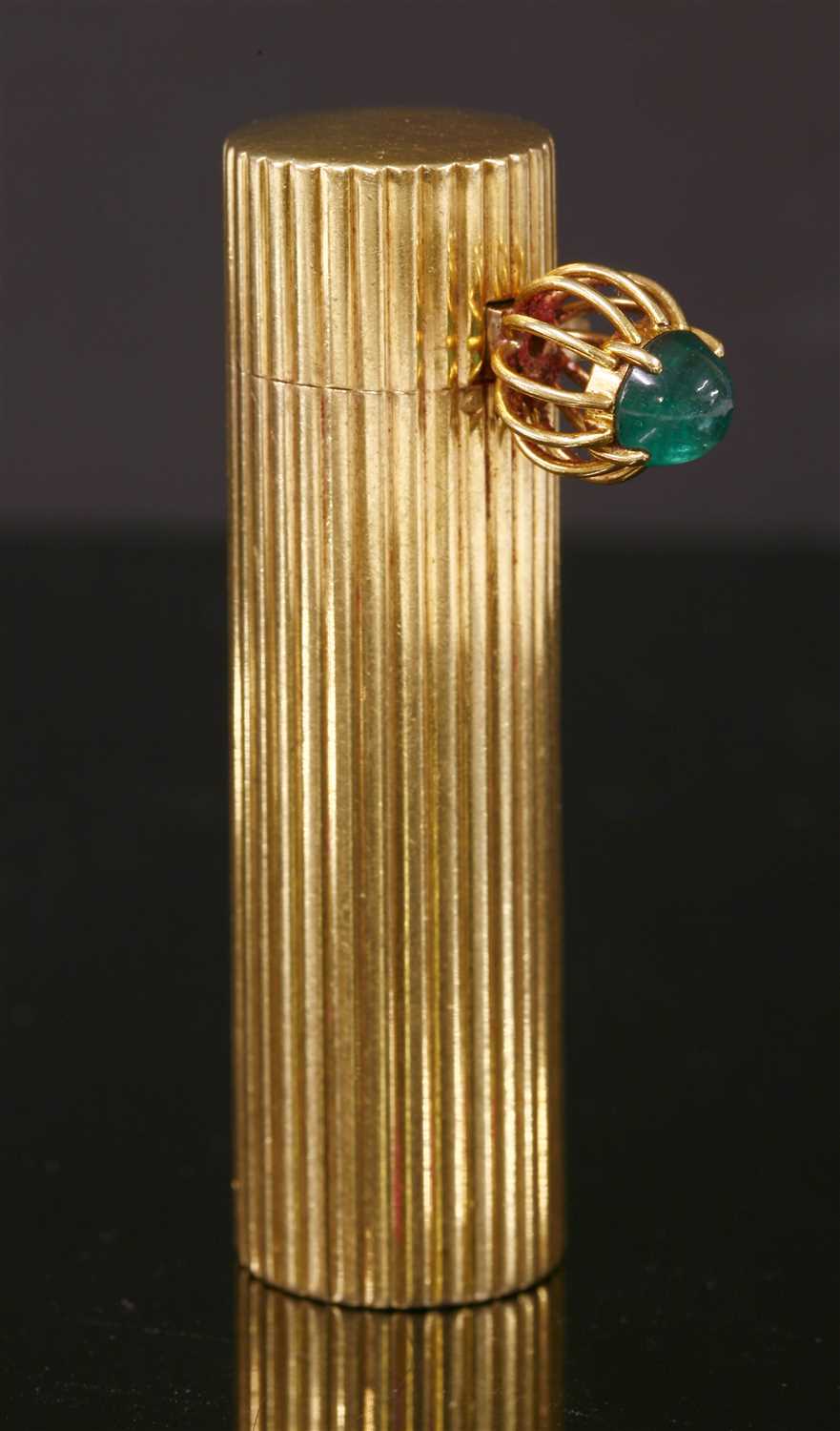 An 18ct gold and silver emerald set Cartier lipstick holder, c.1950,