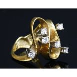 A gold diamond set wave head ring, c.1970