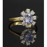 An 18ct gold sapphire and diamond dispersed oval cluster ring,