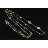 A two colour gold assorted gemstone set chain,