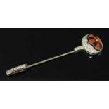 An Art Deco platinum, coral, black paste and diamond set jockey cap jabot or stick pin, c,.1925,