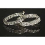 A pair of Continental white gold diamond hoop earrings,