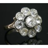 A nine stone diamond daisy cluster ring,