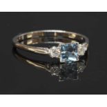 A white gold three stone aquamarine and diamond ring,