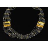 A sixteen row gold haematite and citrine swag or torsade necklace,