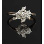 An 18ct white gold diamond cluster crossover ring,