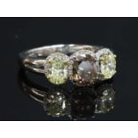 An 18ct white gold three stone fancy diamond and white diamond regal cluster ring,