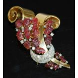 A rose gold and platinum carved ruby and diamond set clip brooch, c.1940,