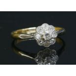 A diamond set daisy cluster ring, c.1920,