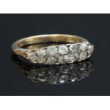 An early 20th century two row diamond carved head ring,