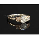 A platinum graduated three stone diamond ring,