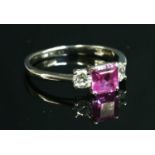 An 18ct white gold three stone pink sapphire and diamond ring,