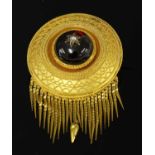 A Victorian Etruscan Revival circular shield form garnet and diamond brooch, c.1860,