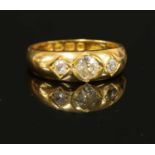 A gentlemen's 18ct gold three stone diamond ring,