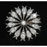 A diamond set flower head brooch/pendant, c.1890,