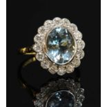 A gold aquamarine and diamond oval cluster ring,