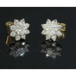 A pair of gold diamond set flowerhead cluster earrings,