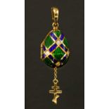 A cased 18ct gold diamond and enamel contemporary egg pendant,