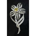 A platinum yellow sapphire and diamond flowerhead brooch, c.1950,