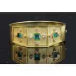A late Victorian or early Edwardian gold, emerald and diamond hinged bangle, c.1900-1910,