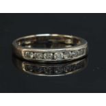 An 18ct white gold diamond set half eternity ring,