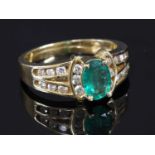 A gold emerald and diamond ring,