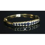 An 18ct gold sapphire and diamond hinged bangle,