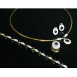 A yellow and white gold sapphire and diamond matched necklace, bracelet, ring and earring suite,