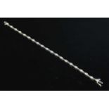 A 9ct white gold diamond set line bracelet,