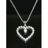 A white gold diamond set heart pendant,