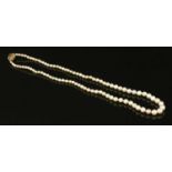 A single row uniform pearl necklace with a diamond set box clasp,