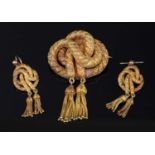 A cased Victorian gold tassel knot brooch and earring suite, c.1850,