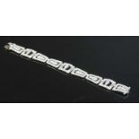 An 18ct white gold diamond set plaque bracelet,