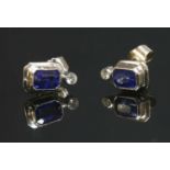 A pair of 18ct white gold sapphire and diamond stud earrings,