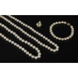 A single row uniform cultured pearl necklace, bracelet and pendant suite,