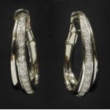 A pair of Continental white gold diamond set elongated half hoop earrings,