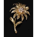 An 18ct gold diamond set flower brooch, c.1970