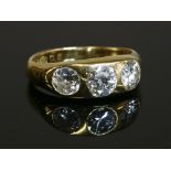 A gentlemen's 18ct gold three stone diamond ring,